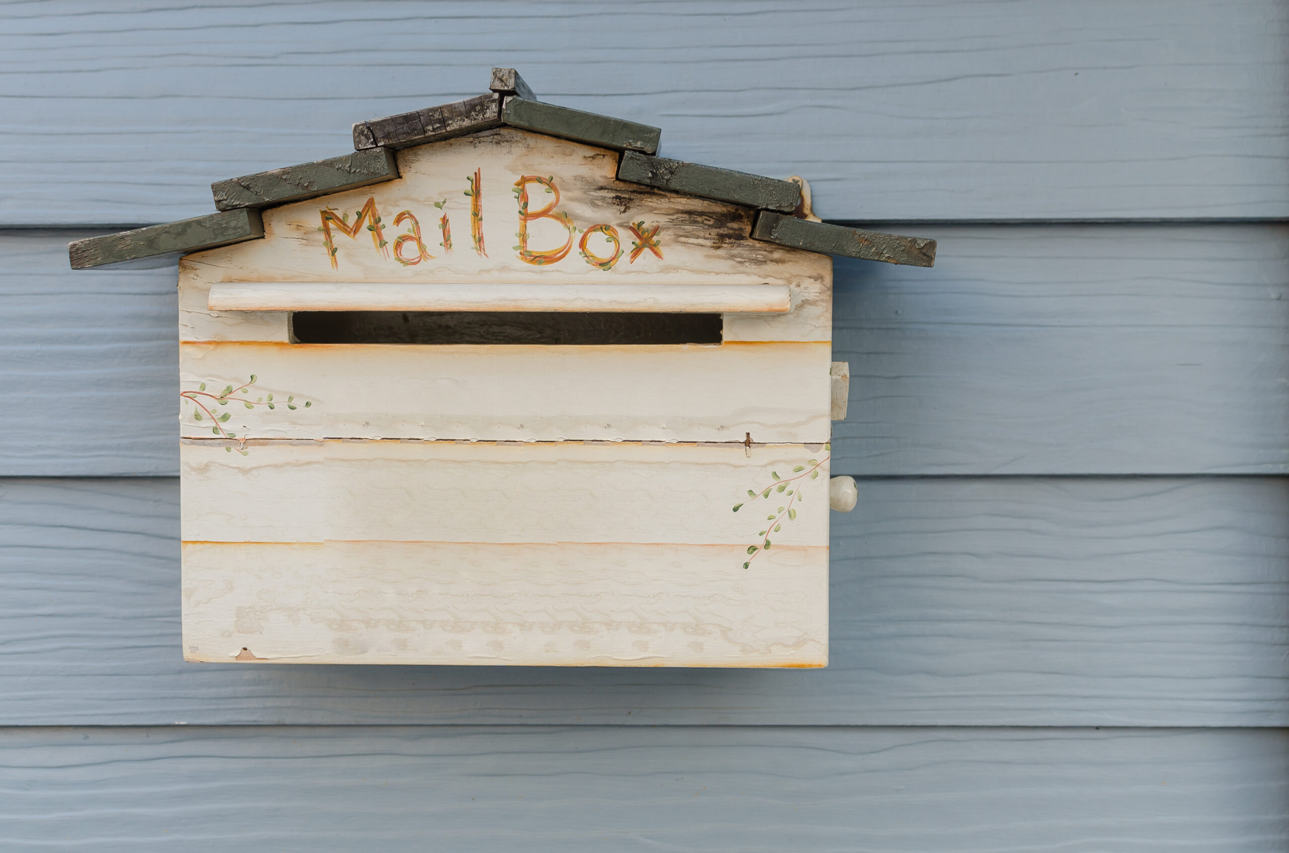 wooden mailbox on wood wall